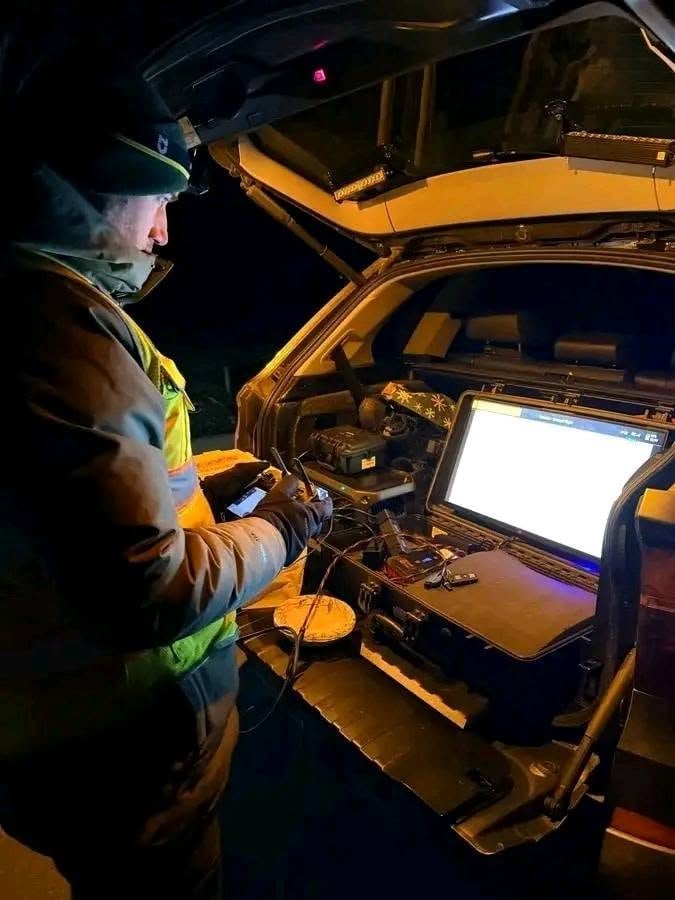 Search operator working from a mobile command vehicle at night